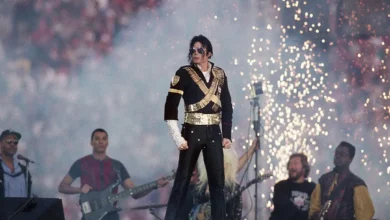 Actor portraying Michael Jackson performing on stage with iconic dance moves, capturing the energy and legacy of the King of Pop