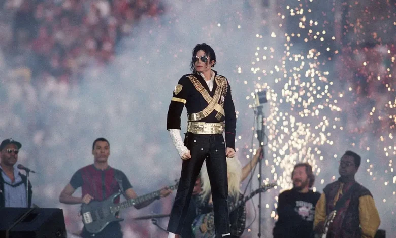 Actor portraying Michael Jackson performing on stage with iconic dance moves, capturing the energy and legacy of the King of Pop