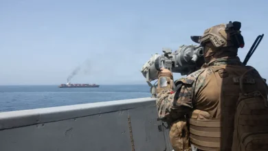 Naval ships navigating a strategic sea route with visible tension, representing global maritime security and geopolitical challenges